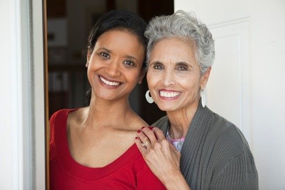Young Woman Smiling with Senior Woman | Senior Home Care in Main Line | Neighborly Home Care