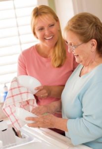 Senior woman and adult daughter washing dishes | elderly parent needs assistance | Neighborly Home Care