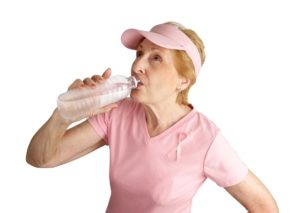 Elderly woman drinking water during exercise | stroke risk factors | Neighborly Home Care