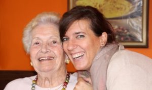 Elderly woman with other adult woman smiling | elderly respite care | Neighborly Home Care