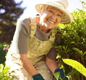 Senior Woman in Sunhat gardening | Springtime Activities for Seniors | Neighborly Home Care