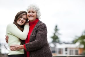 Elderly woman and young adult woman hugging | exploring dementia | Neighborly Home Care