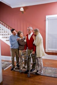 Senior man with caregiver and others | caregiver burnout | Neighborly Home Care